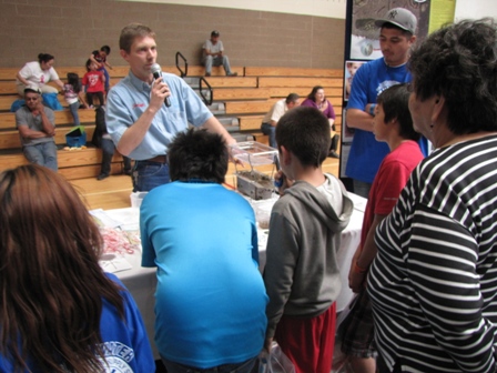 Man with microphone demonstrating a rainfall simulator